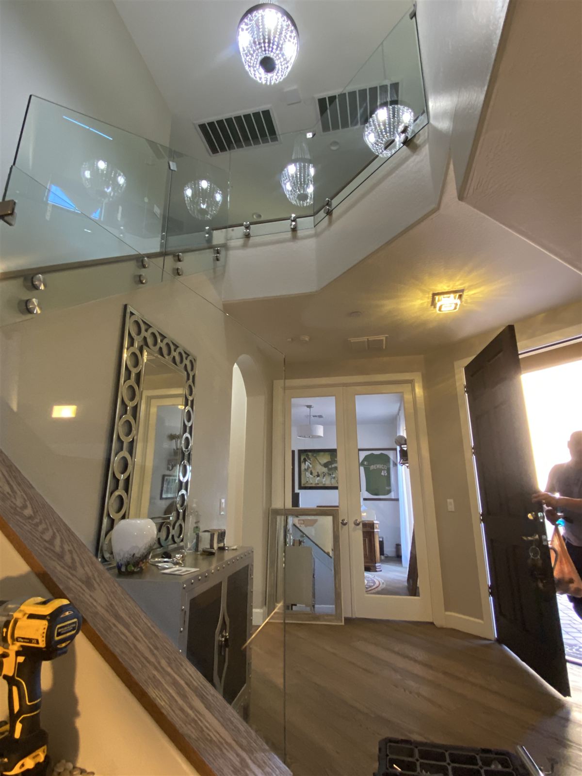 Glass balcony railing over a two-story entry